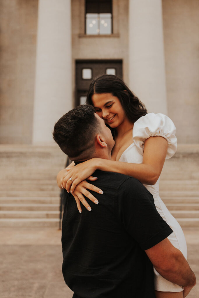 couple embraces in front of Ohio Statehouse