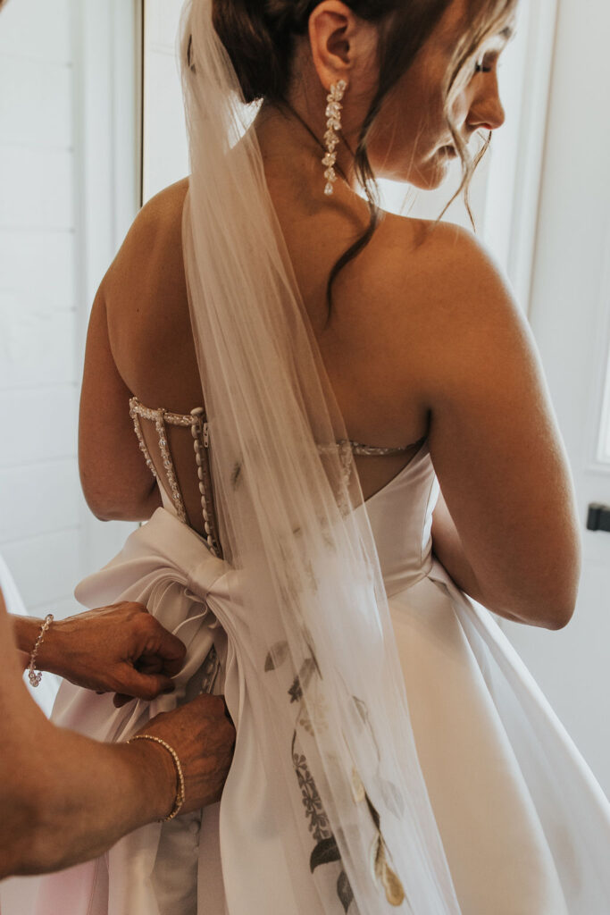 bride getting into her wedding dress
