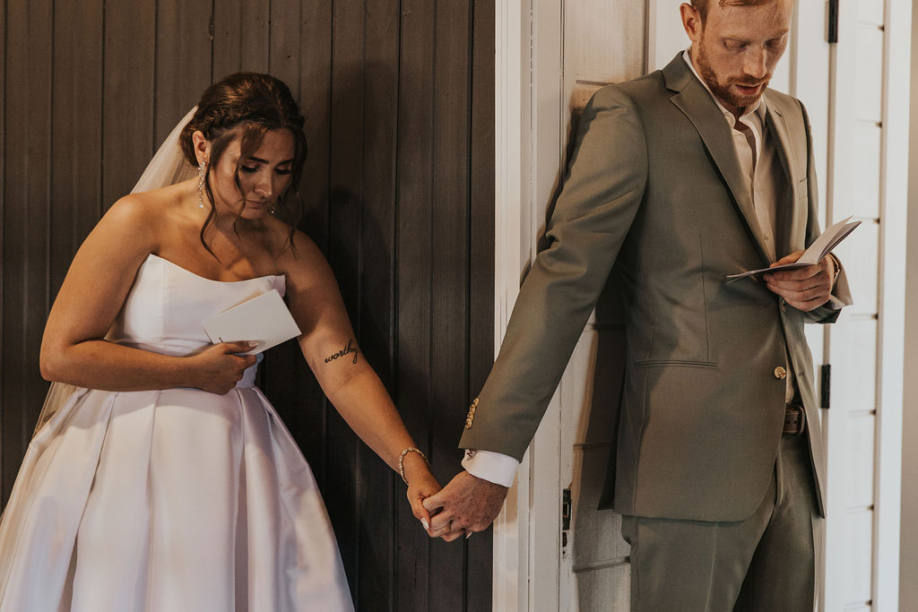 couple reads private vows to each other while holding hands