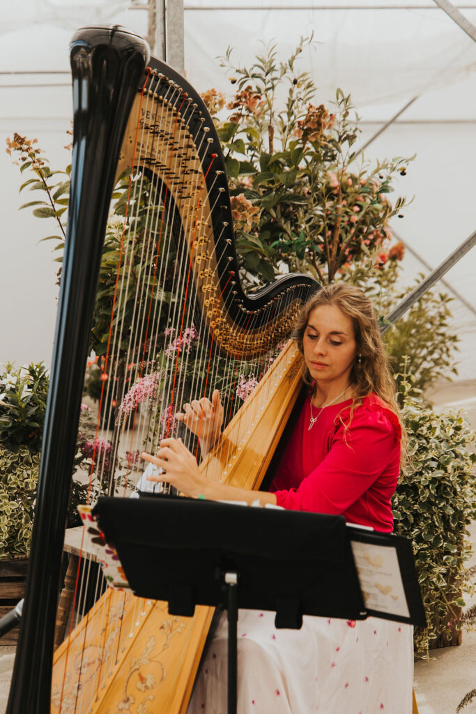 harpist playing during ceremony at Ohio greenhouse