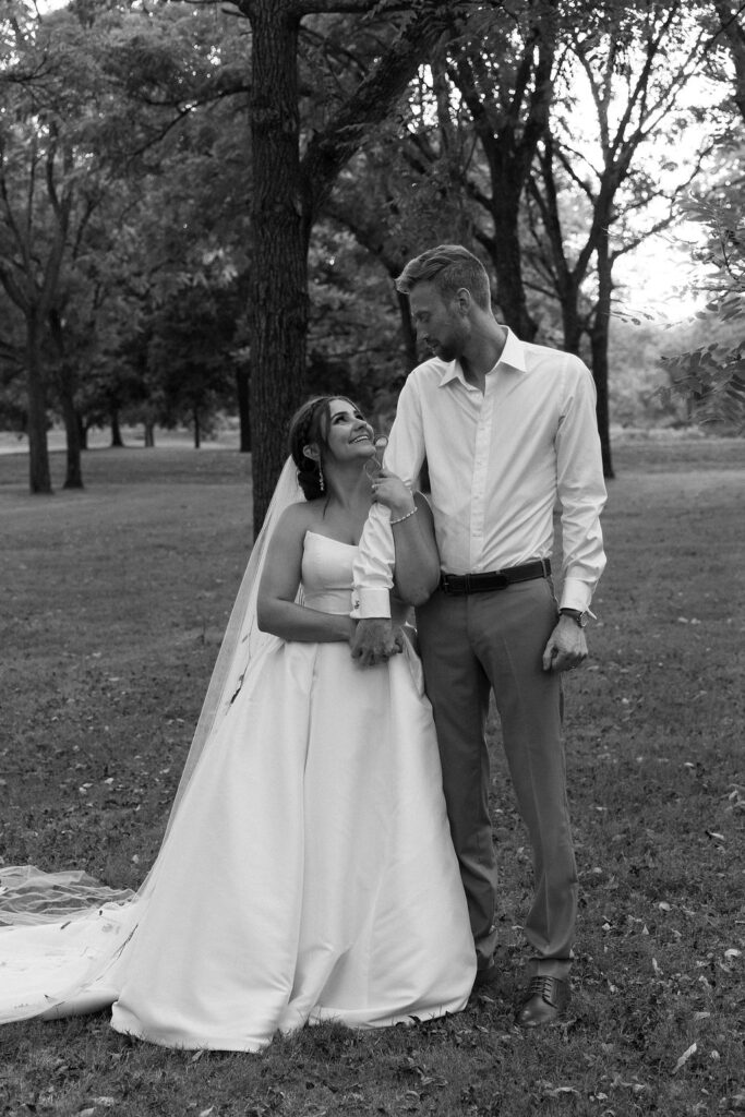 couple pose together among the trees