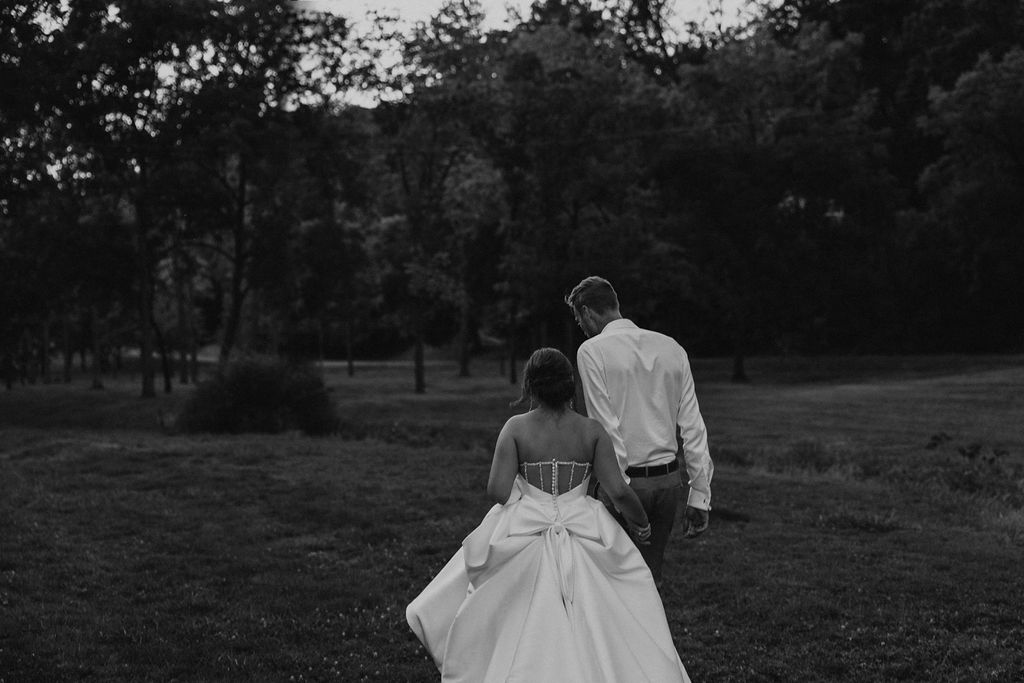 couple walking along grassy landscape