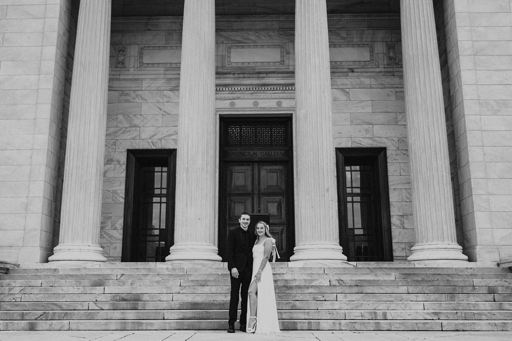 couple pose in front of pillars