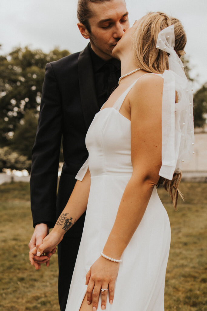 couple kiss showing off outfits