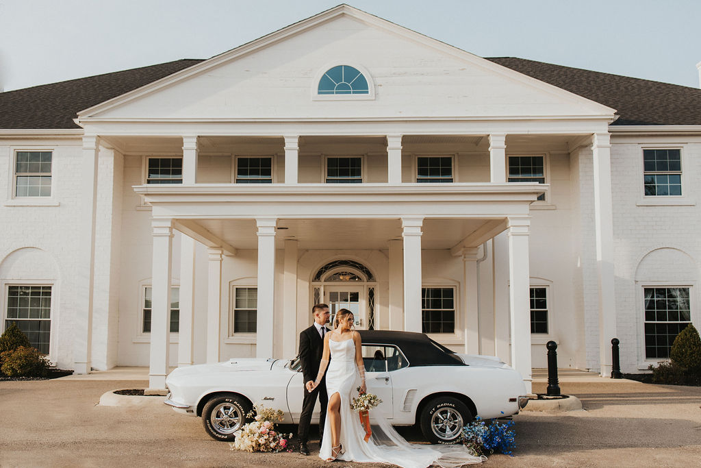 couple poses with car in front of Westbrook Country Club