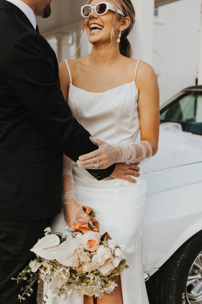 couple poses with car in front of Westbrook Country Club