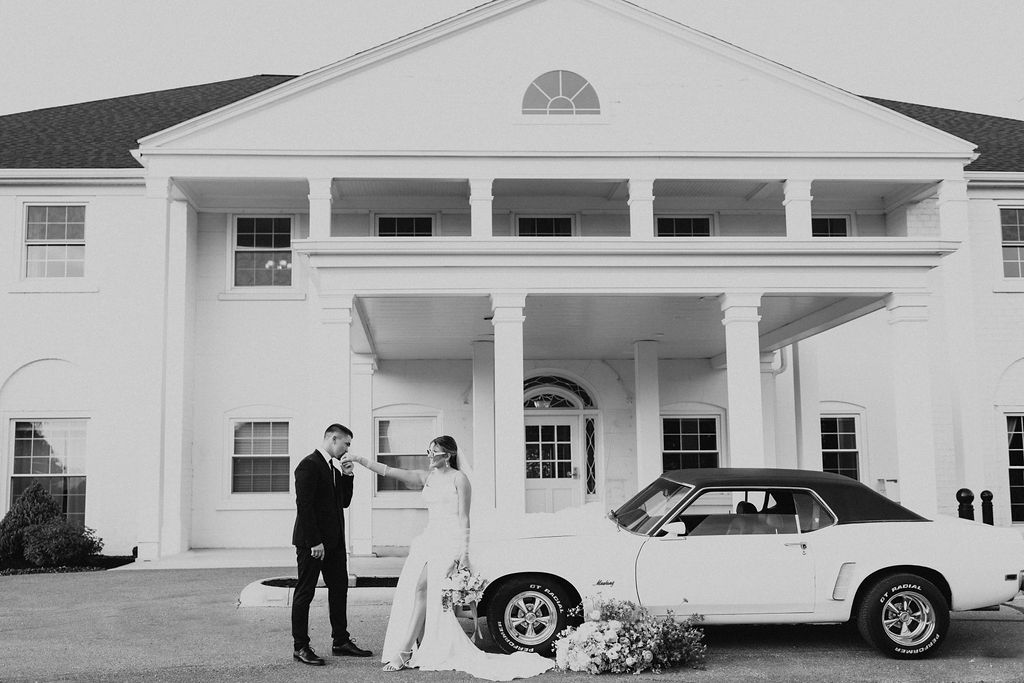 couple poses with car in front of Westbrook Country Club