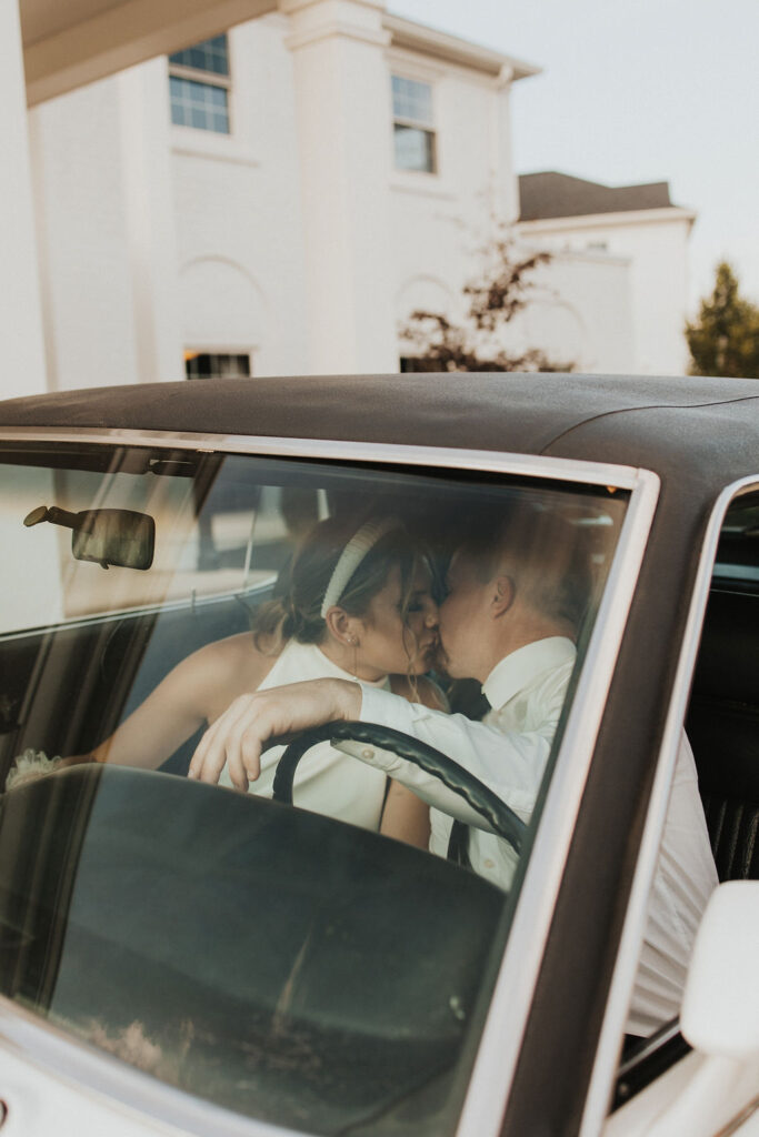 couple kiss in classic car