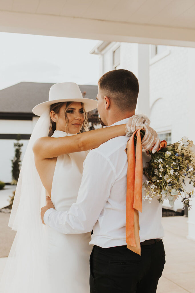couple poses in front of Westbrook Country club