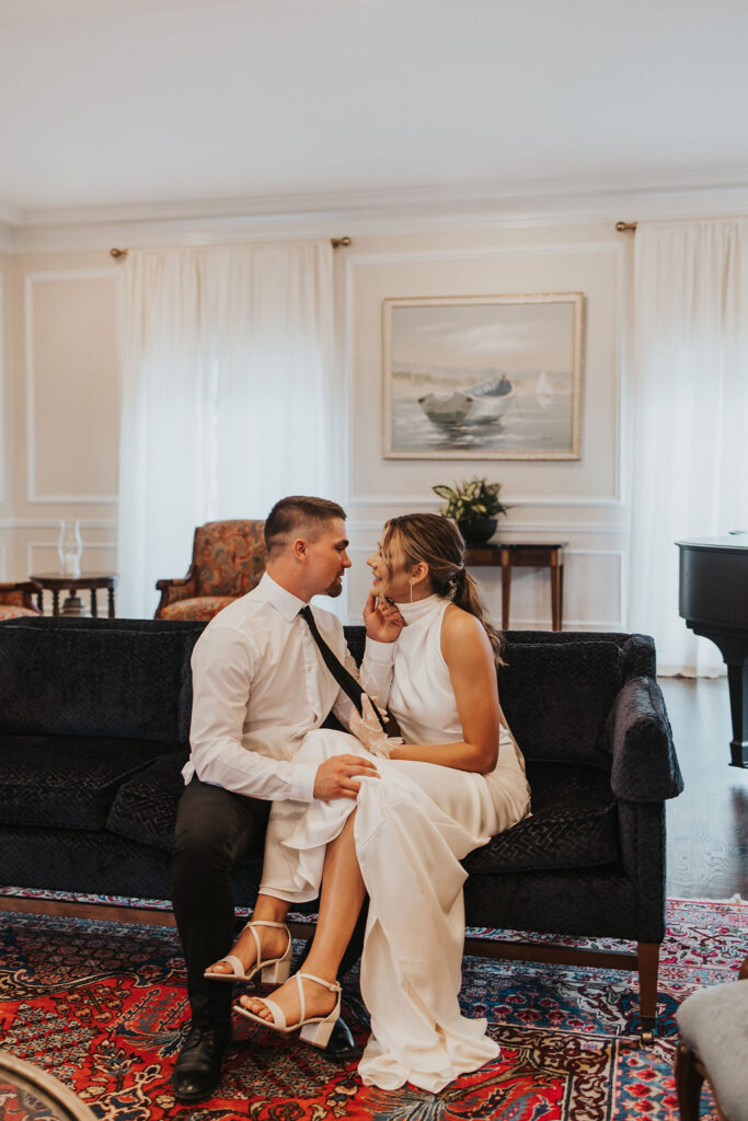 couple pose on couch in the Westbrook Country club