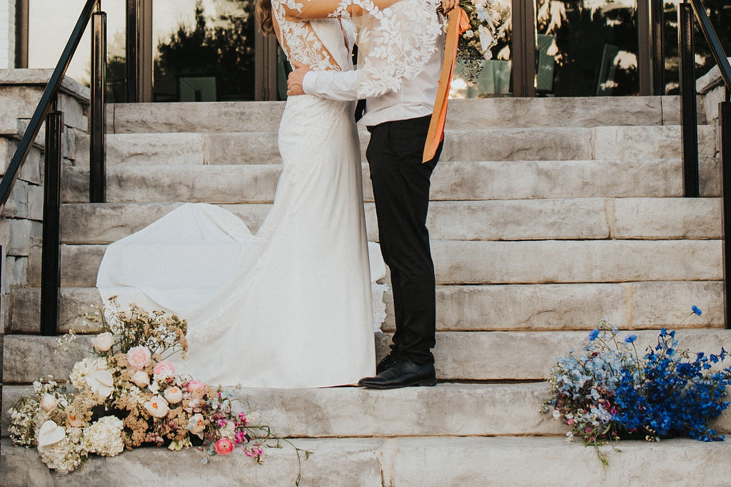 detail shot of wedding outfits and flowers on steps