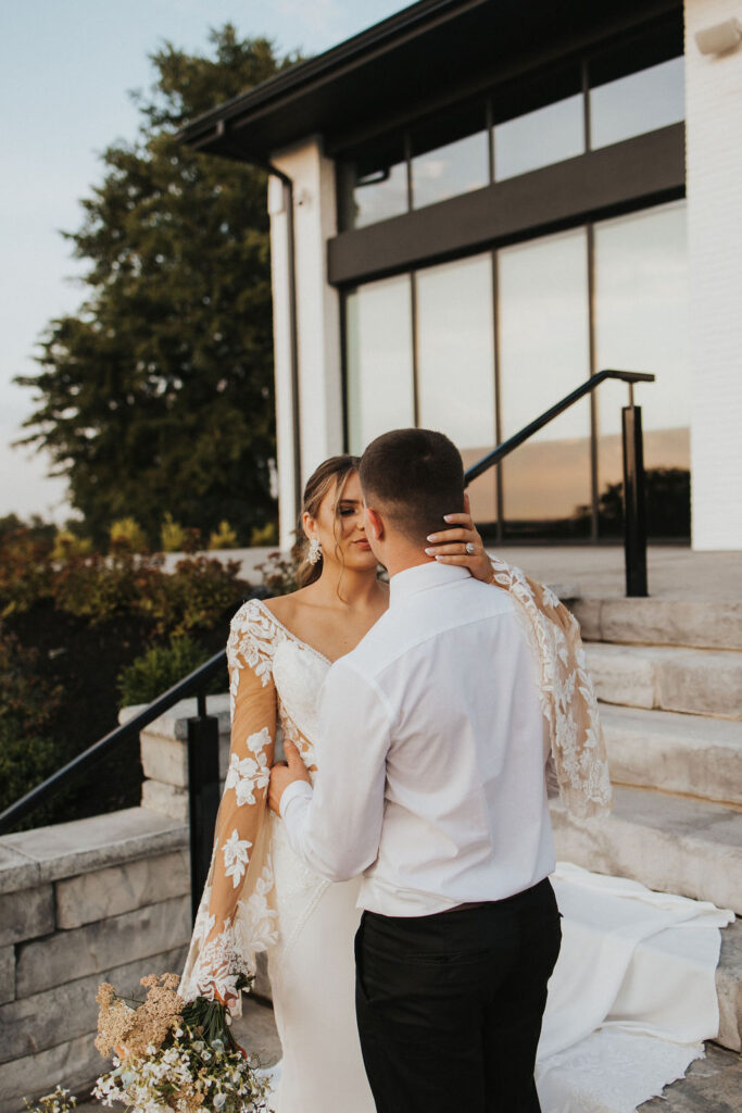 couple embrace on steps of Westbrook Country club