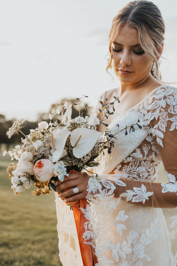 bridal portrait of bride with wedding bouquet at sunset